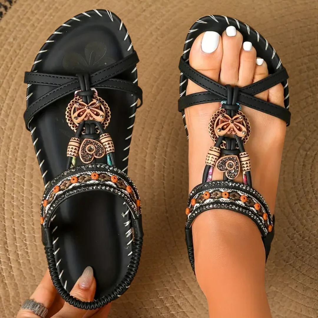 Black orthopedic strappy sandal with metallic charm and embellished band