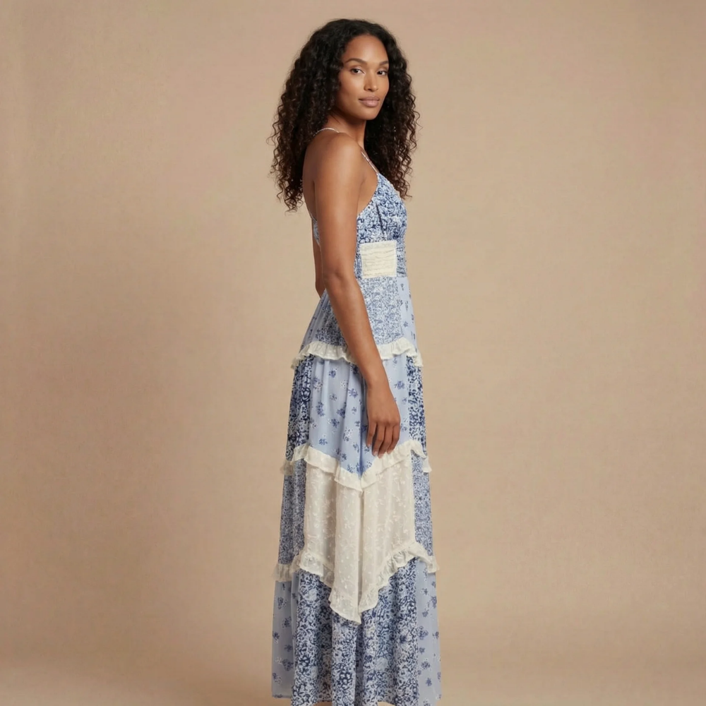 Blue floral V-neck maxi dress with tiered ruffles and cream trim, side view