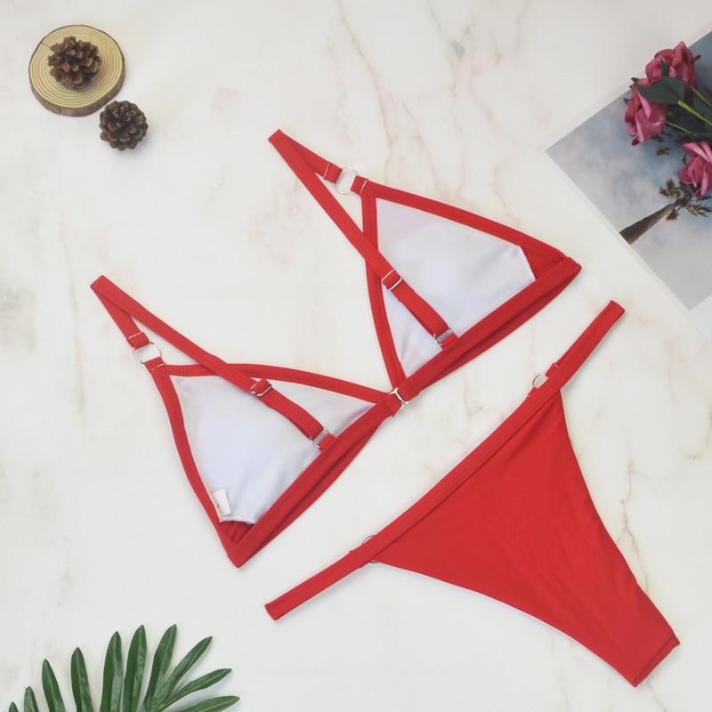 Red triangle bikini with metal rings, white contrast lining visible