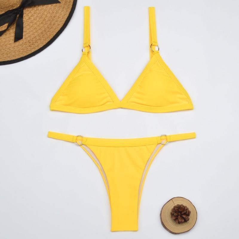 Yellow triangle bikini top and bottom with metal rings flat lay