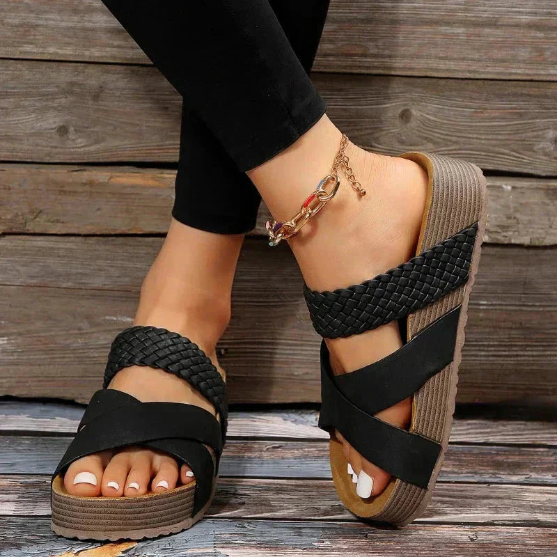 Black woven platform sandal with cushioned contoured footbed and straps