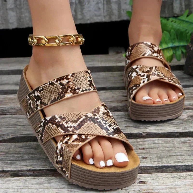 Snake print platform sandal with dual crossover straps and contoured sole