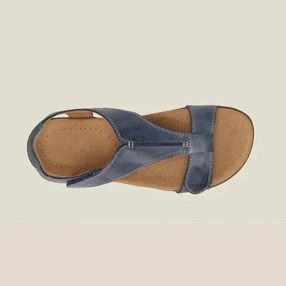 Overhead view of navy blue t-strap orthopedic sandal showing footbed and strap design