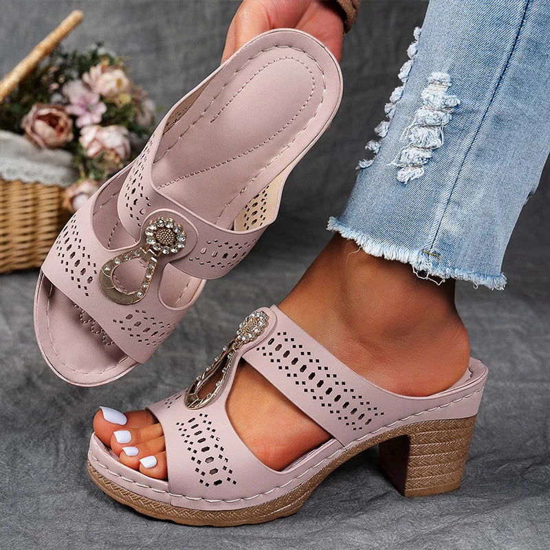 Mauve perforated block heel sandal mule sole view showing cushioned footbed and gold hardware