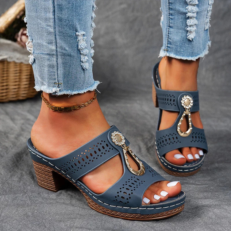 Navy blue perforated block heel sandal mule with white topstitching and gold buckle