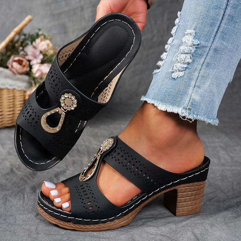 Black perforated block heel sandal mule sole with white stitching and gold chain hardware