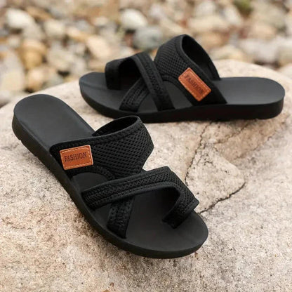 Flat lay of black textured cushioned sandals showing adjustable strap design