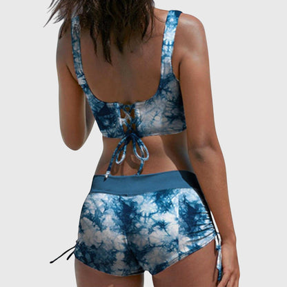 Back view of blue tie-dye bikini with lace-up back closure and side-tie shorts