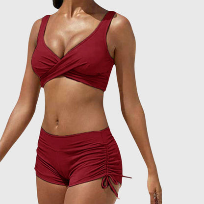 Burgundy two-piece bikini with wrap-front top and ruched side-tie shorts