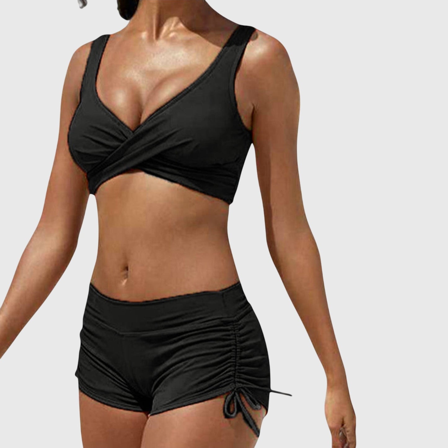 Black two-piece bikini with wrap-front top and ruched side-tie shorts