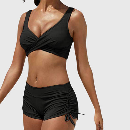 Black two-piece bikini with wrap-front top and ruched side-tie shorts