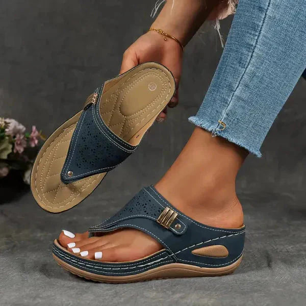 Black thong orthopedic sandal sole view displaying perforated upper and supportive contoured base