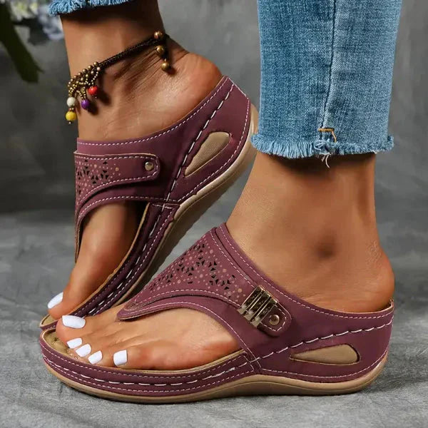 Burgundy perforated thong orthopedic sandal with metallic buckle and cushioned wedge heel